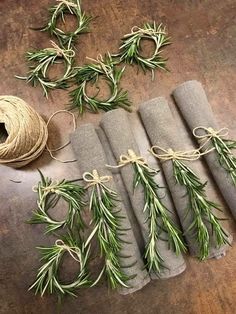 four rolls of twine tied together with sprigs of rosemary on the side