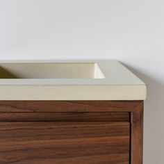 a white sink sitting on top of a wooden cabinet