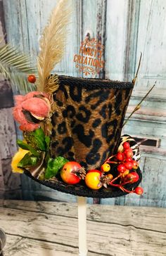 Mini top hat leopard print fabric, ostrich feather, berries and mini pumpkins. Easter Arrangement, Mini Hats, Leopard Print Fabric, Mini Top Hat, Mini Top, Ostrich Feather, Mini Pumpkins, Buying A New Home, Ostrich Feathers