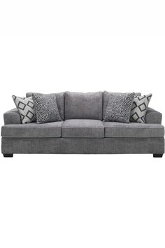 a gray couch with two pillows on it and some black and white pillows in the back