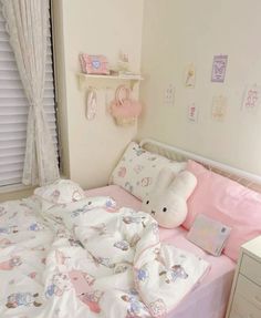 a child's bedroom with pink and white bedding, teddy bear pillowcases and other items