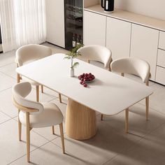 a white table with four chairs and a vase on it in a room that has tile flooring