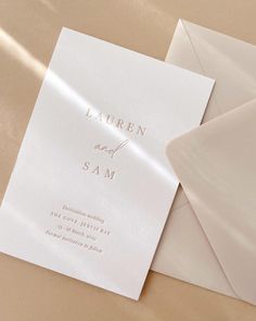 the wedding stationery is laid out on top of each other, including an envelope