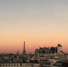 the eiffel tower towering over paris at sunset