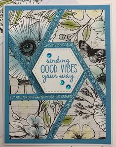 a close up of a card with flowers and butterflies on the front, which reads sending good vibes your way