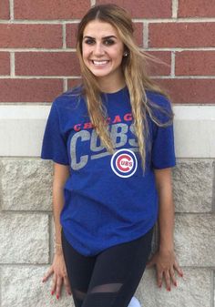 a woman with long hair wearing a chicago cubs t - shirt and leggings