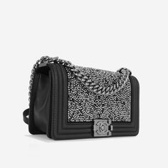 The ‘Boy’ bag, first introduced in 2011 and named after Coco Chanel’s lifetime love, is part of their iconic collection. This particular edition is created using calfskin leather, adorned with luxurious silver and black crystals. can be with the chain doubled up over the shoulder for an evening look or wear cross body for a more casual style. SPL Exterior Black lambskin leather Black / Silver-toned crystal gromet beads Silver-tone hardware Chain strap with leather shoulder feature Push lock closure 2019 production Excellent condition - slight tarnishing to push-lock hardware / minor rubbing to corners Interior Matching interior One slip pocket Chanel embossed logo Excellent condition - some make up marks to interior fabric and flap Sold with box, dust bag, card and redacted receipt SPL Hei Luxury Evening Box Bag With Silver-tone Hardware, Luxury Bags With Silver-tone Hardware, Luxury Black Box Bag With Silver-tone Hardware, Luxury Silver-tone Hardware Box Bag For Evening, Luxury Men's Bags With Silver-tone Hardware, Interior Fabric, The Boy, Black Crystals, Embossed Logo