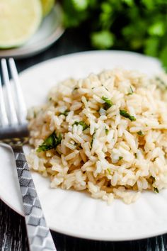 a white plate topped with rice next to a fork