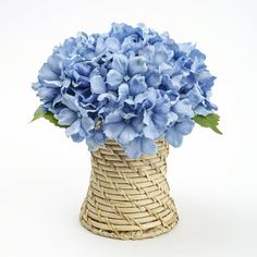 a wicker vase with blue flowers in it on a white background, for decoration