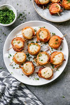 small appetizers are arranged on a plate with toothpicks and garnishes