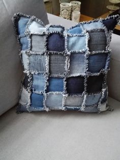 a pillow made out of old jeans on a couch