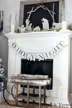 a living room decorated for christmas with white furniture and decorations on the fireplace mantel