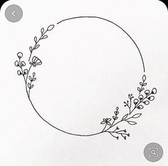 a black and white drawing of a circle with flowers on it, surrounded by smaller circles