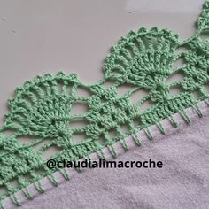 the crocheted lace is green and has two rows of stitches on it, along with