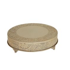 an ornately decorated round metal box