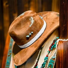 Elevate your Western style with our artisan-styled vegan suede cowboy hat, adorned with exquisite gold leaf detailing and vibrant turquoise stones. This hat features a unique hand-burned design, creating a one-of-a-kind piece that stands out. The leather and lace hatband, accented with delicate feather details, adds a touch of rustic elegance.  Perfect for festivals, rodeos, or everyday wear, this hat combines the rugged charm of the Old West with modern, style. The person who wears this hat wil Southwestern Turquoise Hat For Ranch, Southwestern Style Turquoise Hat For Ranch, Western Turquoise Festival Hats, Western Style Turquoise Festival Hats, Turquoise Country Hat For Western-themed Events, Artisan Turquoise Hats For Western-themed Events, Artisan Turquoise Hat For Western-themed Events, The Old West, Cowgirl Hat