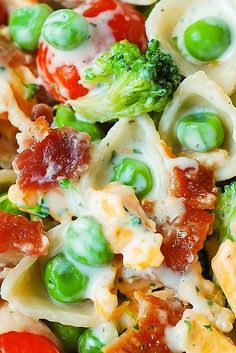 a pasta salad with peas, tomatoes and broccoli