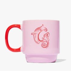 a pink and red coffee mug with the letter c on it