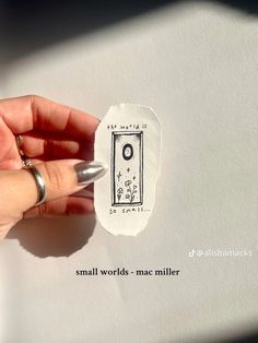 a hand holding a stamp that says small words - mac miller