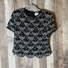 "90s Vintage Papell Boutique Silk Beaded Black Scallop Top Excellent condition! Size Large Petite Pit-to-Pit: 18\" Length: 20\" Formal evening blouse Short sleeve top 100% silk Back hidden zipper closure Scoop neckline Cap sleeves Shoulder Pads Tapered at waist Scalloped hem Lined Tags Party, cocktail, gorgeous, luxury, designer, formalwear, dinner, special occasion, special event, wedding, beautiful, pretty, sparkle, shimmer, boho, indie, Christmas, new years eve" Elegant Embroidered Tops For Night Out, Glamorous Embellished Short Sleeve Blouse, Glamorous Short Sleeve Embellished Blouse, Fitted Crew Neck Evening Top, Fitted Evening Tops With Crew Neck, Fitted Embroidered Glamorous Top, Glamorous Embroidered Fitted Top, Fitted Glamorous Embroidered Tops, Glamorous Embroidered Party Tops