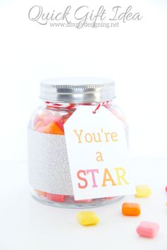 a jar filled with candy sitting on top of a table