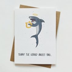 a card with an image of a shark holding a banana in it's mouth