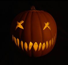 a carved pumpkin with sharp teeth on it