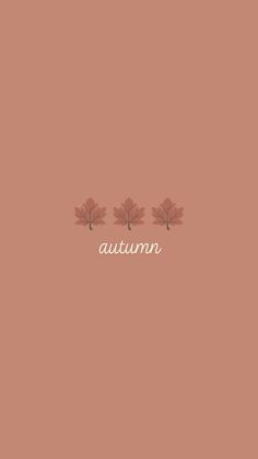 the word autumn written in white on a pink background with two maple leaves above it