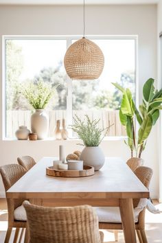 a dining room table with some plants in it