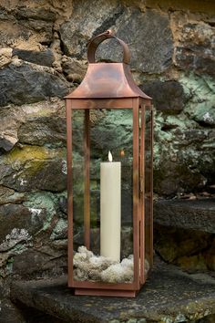 a candle that is sitting on some rocks