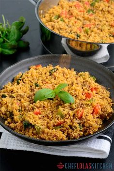 two pans filled with rice and vegetables on top of a black countertop next to each other