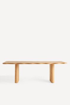 a wooden table sitting on top of a white floor