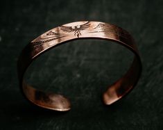 💎 Handcrafted with meticulous attention to detail, this adjustable copper cuff is a symbol of strength, rebirth, and personal transformation. 💎 Made from high-quality, pure copper, this handmade bangle is designed to harness the therapeutic benefits associated with copper. Copper has been revered for centuries for its potential to improve overall well-being and promote positive energy flow within the body. 💎 This special copper cuff features a captivating engraved phoenix design, representing Adjustable Symbolic Cuff Bangle Bracelet, Adjustable Etched Brass Cuff Bracelet, Adjustable Etched Cuff Jewelry, Adjustable Brass Etched Cuff Bracelet, Adjustable Symbolic Cuff Bracelet, Unique Adjustable Rose Gold Bracelet, Adjustable Unique Rose Gold Bracelet, Adjustable Unique Rose Gold Bracelets, Engraved Copper Bracelet Jewelry