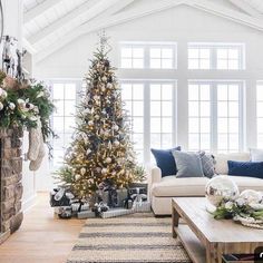 a living room filled with furniture and a christmas tree