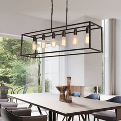 a dining room table with six chairs and a chandelier hanging from the ceiling