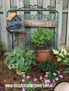 there is a birdhouse and flowers in the garden