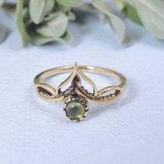 Crown Brass Design Peridot Ring, Retro crown ring, Peridot jewelry, Vintage Ring, Gold Ring, Boho Ring, Dainty cute, Elegant gemstone ring Enjoy Free Shipping on All Orders Product Description:-  *Handmade item *Dispatches from a small business in India *Materials         :-   Brass, Silver *Band colour    :-   Gold, Silver *Style                 :-   Boho & hippie *Can be personalized PRODUCT CODE     :-  SIZE           :-    All Size Are Available. Choose From Variation. METAL           :-     Brass, 925 sterling silver STONE                    :-      Peridot STONE SHAPE        :-     Round Ring can be customized on request and gemstone can be made to any gemstone you want. If You Need Faster Shipping, Please Contact us Please Make Sure to Include The Correct Address During Before Order Art Nouveau Gemstone Ring Jewelry, Art Nouveau Gemstone Jewelry, Handmade Peridot Wedding Rings, Art Nouveau Gemstone Rings With Round Shape, Art Nouveau Gemstone Rings With Round Cut, Art Nouveau Gemstone Rings For Gifts, Art Nouveau Wedding Ring With Cabochon, Art Nouveau Wedding Ring With Gemstone, Art Nouveau Gemstone Wedding Ring