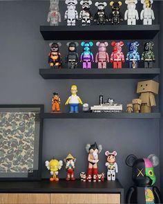 a shelf filled with lots of toy figurines on top of it