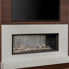 a large flat screen tv mounted above a fireplace