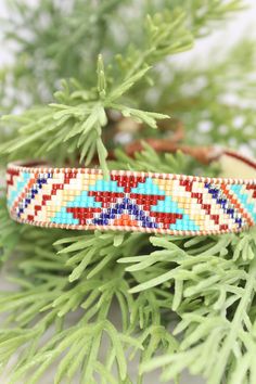 Introducing our adjustable southwestern beaded cuff bracelets! This colorful cuff bracelet is handmade with a southwestern-inspired pattern in cream, dark red, blue, orange, turquoise, and soft yellow.The bracelet is strung on strong beading thread and flexible leather cord with an adjustable closure, making it easy to put on and take off, while also allowing you to customize your fit. It will fit 6-8 inch wrists.Whether you're dressing up for a special occasion or just accenting your everyday s Bohemian Beaded Cuff Bracelet, Bohemian Cuff Bracelet With Round Beads For Festivals, Bohemian Festival Cuff Bracelet With Round Beads, Southwestern Adjustable Beaded Bracelets, Southwestern Adjustable Beaded Bracelets As Gift, Adjustable Southwestern Blue Cuff Bracelet, Southwestern Style Adjustable Beaded Bracelets As Gift, Adjustable Beaded Bohemian Cuff Bracelet, Bohemian Beaded Bracelets With Adjustable Band