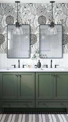 a bathroom with green cabinets and two mirrors