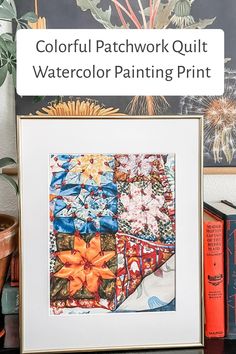 colorful patchwork quilt watercolor painting print displayed on shelf next to books and plant