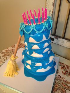 a blue and white cake with candles on it