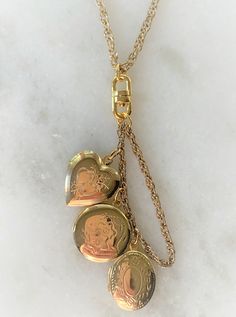 "29\" Floral & Heart Engraved Triple Lockets Necklace on Chain Each Chain Necklace has 1 Heart - 1 Oval - 1 Round Locket Lockets Open with 2 Sides for Photos Lockets Measure Approximately 3/4\" Spring Ring Closure Polished Gold Tone or Polished Silver Tone Made in USA COMPLIMENTARY DOMESTIC SHIPPING" Vintage Gold Locket Necklace With Lobster Clasp, Gold-tone Medallion Charms Jewelry, Gold-tone Locket Necklace, Gold Locket Necklace With Adjustable Chain, Gold Medallion Chain Necklace With Charms, Gold Chain Charm Necklace For Anniversary, Vintage Charm Necklace With Heart Pendant For Memorial, Vintage Heart Pendant Necklace For Memorial, Vintage Charm Necklaces With Heart Pendant For Memorial