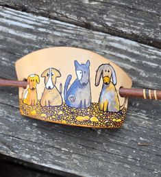 a wooden stick with dogs painted on it