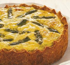 a quiche with cheese and green peppers on top