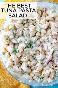 the best tuna pasta salad in a glass bowl on a yellow and blue tablecloth