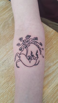 a tattoo on the arm of a person with a heart and flowers in the center