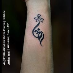 a black and white tattoo on the arm of a person with a flower in it