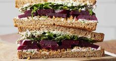 a sandwich with beets, lettuce and cheese